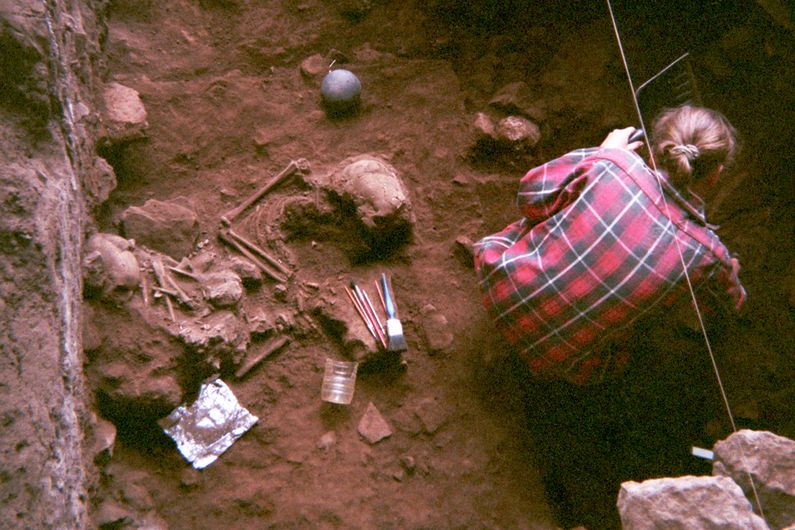 Excavation of a double burial at Shum Laka Rockshelter in Cameroon, containing the remains of two boys who lived ~8000 years ago and who were genetically from the same family. Ancient DNA reveals that these two individuals and another pair of children buried three millennia later at Shum Laka were from a stable population that was then almost completely replaced by the very different populations living in Cameroon today.