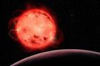 Cette représentation artistique de l'étoile naine rouge TRAPPIST-1 met en évidence sa nature très active. L'étoile semble avoir de nombreuses taches stellaires (des régions plus froides de sa surface, semblables aux taches solaires) et des éruptions. L'exoplanète TRAPPIST-1 b, la planète la plus proche de l'étoile du système, est visible au premier plan, sans atmosphère apparente. L'exoplanète TRAPPIST-1 g, l'une des planètes de la zone habitable du système, est visible à l'arrière-plan, à droite de l'étoile. Le système TRAPPIST-1 contient sept exoplanètes dont la taille est semblable à celle de la Terre.