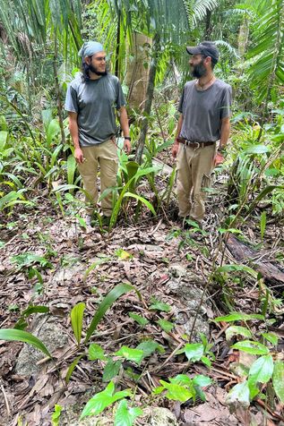 Anthropology postdoc Jean-Baptiste LeMoine and Roberto stand at the edge of an ancient wall bordering the eastern part of the town of Ucanal.