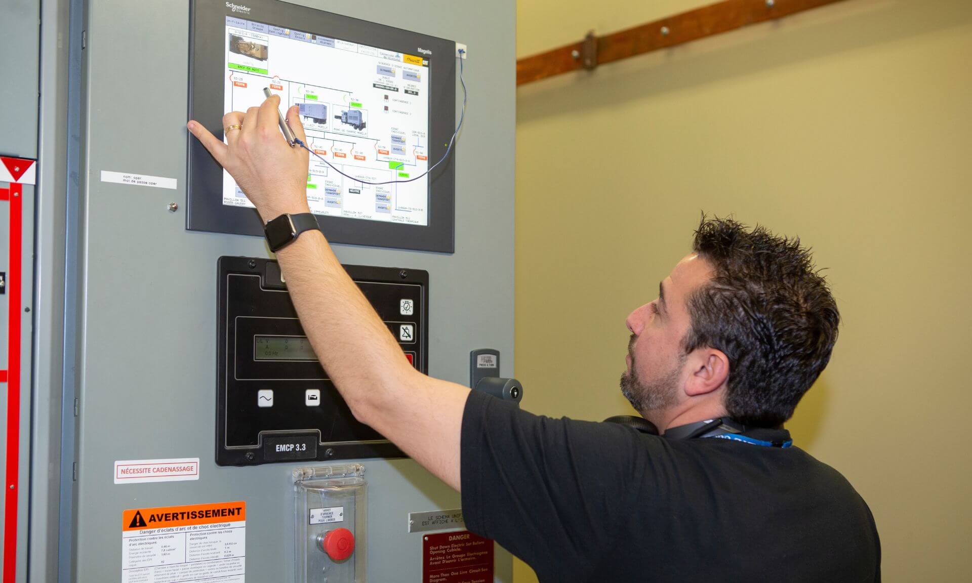 Un électromécanicien supervise le transfert des charges sur l'une des génératrices.