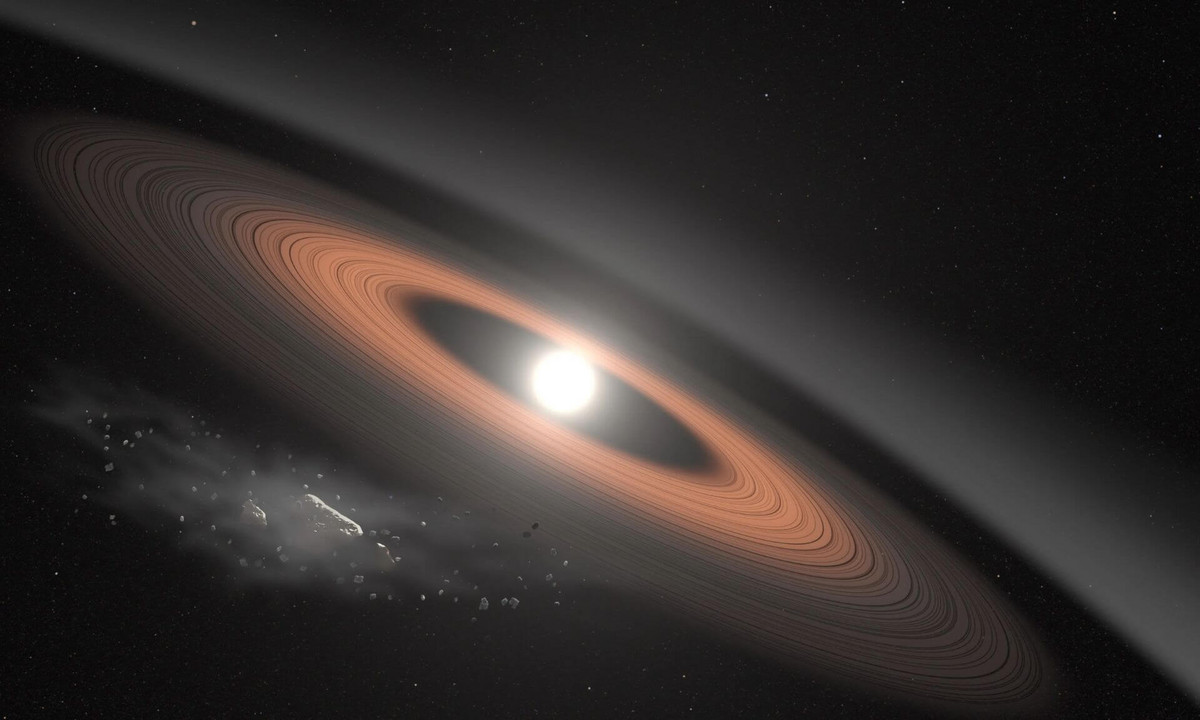 In this illustration, an asteroid (bottom left) breaks apart under the powerful gravity of LSPM J0207+3331, the oldest, coldest white dwarf known to be surrounded by a ring of dusty debris. Scientists think the system’s infrared signal is best explained by two distinct rings composed of dust supplied by crumbling asteroids.